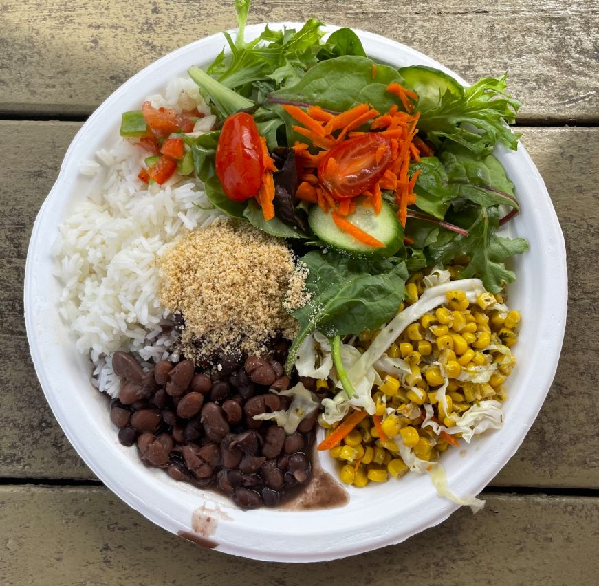 Top down view of plate with rice, beans, and salads