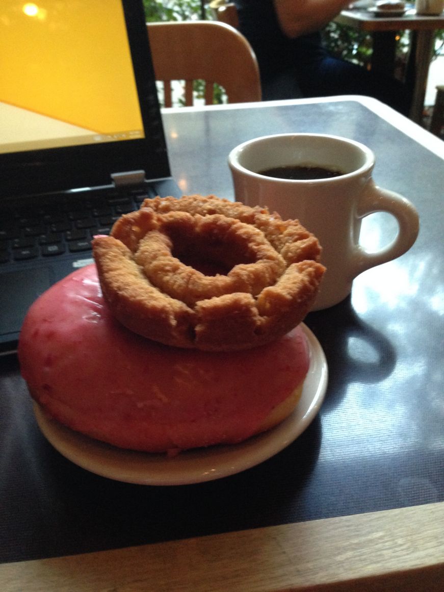 The tools of a food blogger's craft: doughnuts, coffee, and a laptop