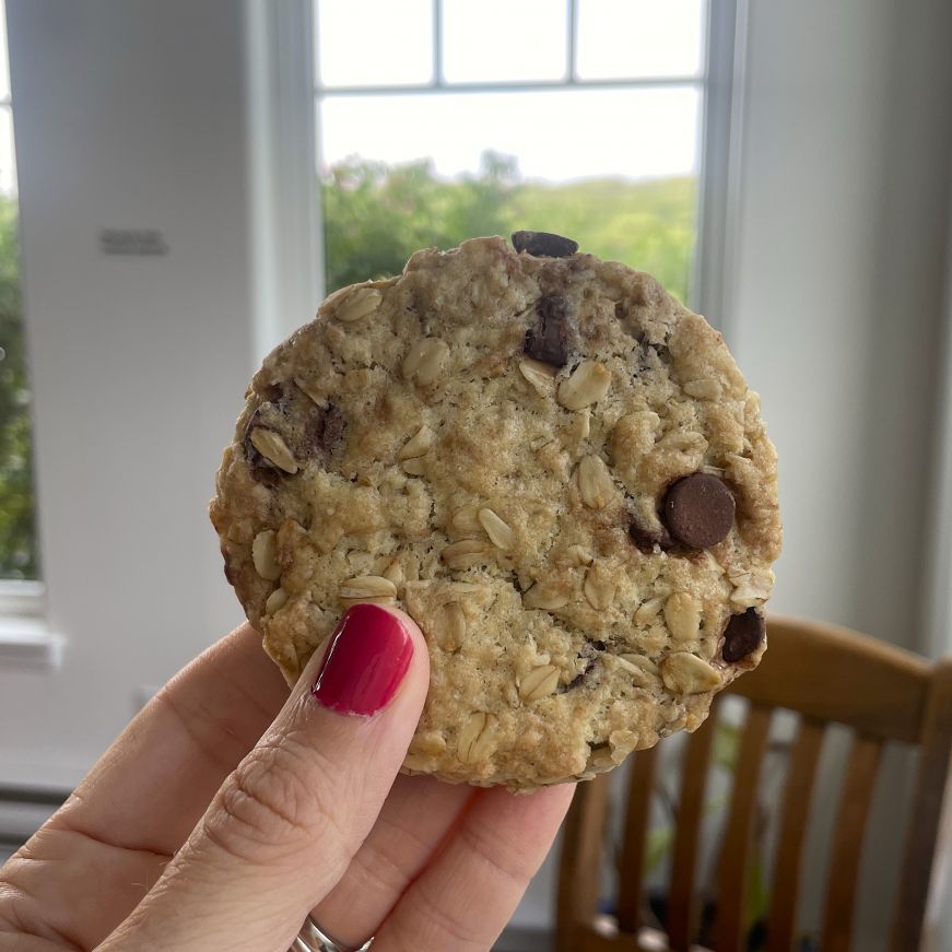 Chocolate chip oatcake, Just Us! Hand holding a chocolate chip oatcake