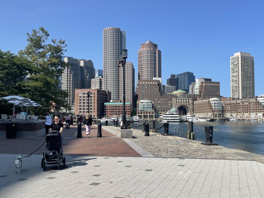 Walking path along a pier with the Boston skyline in the background