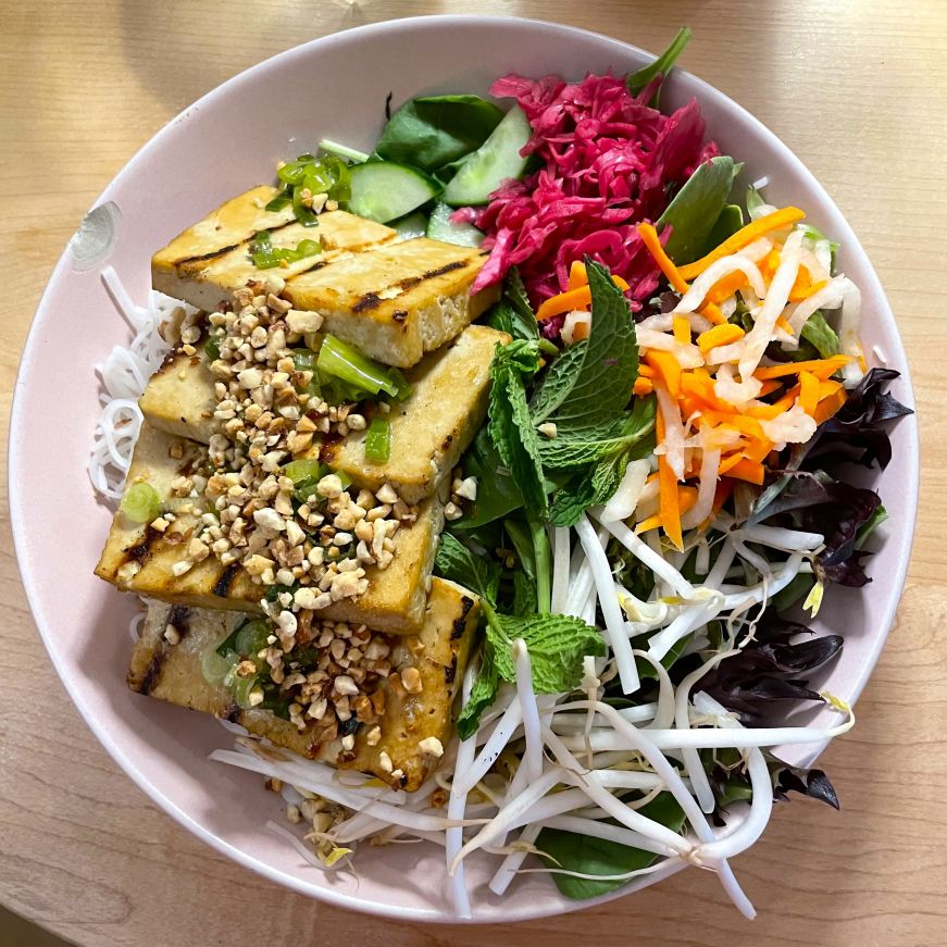 Noodle bowl topped with tofu and vegetables