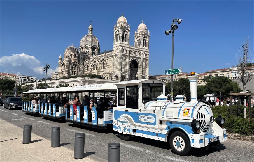 Tram driving in front of a large church