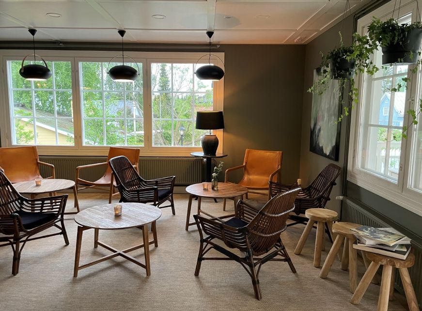 Lounge area with several chairs and small tables