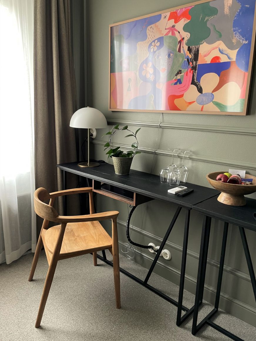 Desk and wooden chair in the corner of a hotel room