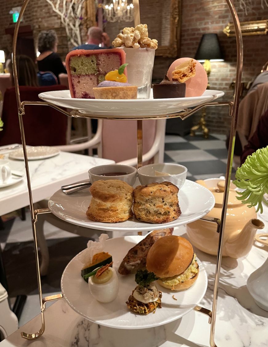 Three-tiered tea tower with miniature sandwiches, scones, and desserts