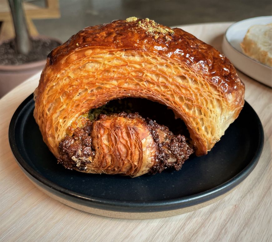 Close up of a croissant with a pistachio filling