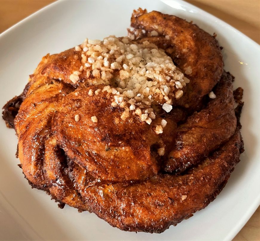 Swirled cardamom bun topped with pearl sugar