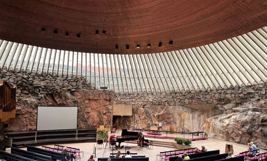 Interior of modernistic church with a stone walls and a copper ceiling