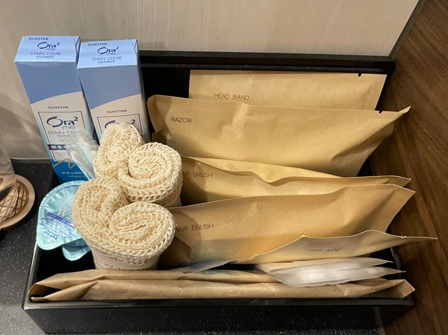 Box with toiletries on a hotel bathroom counter