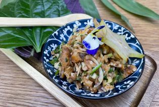 Bowl of crispy fish pieces with lettuce leaves on side